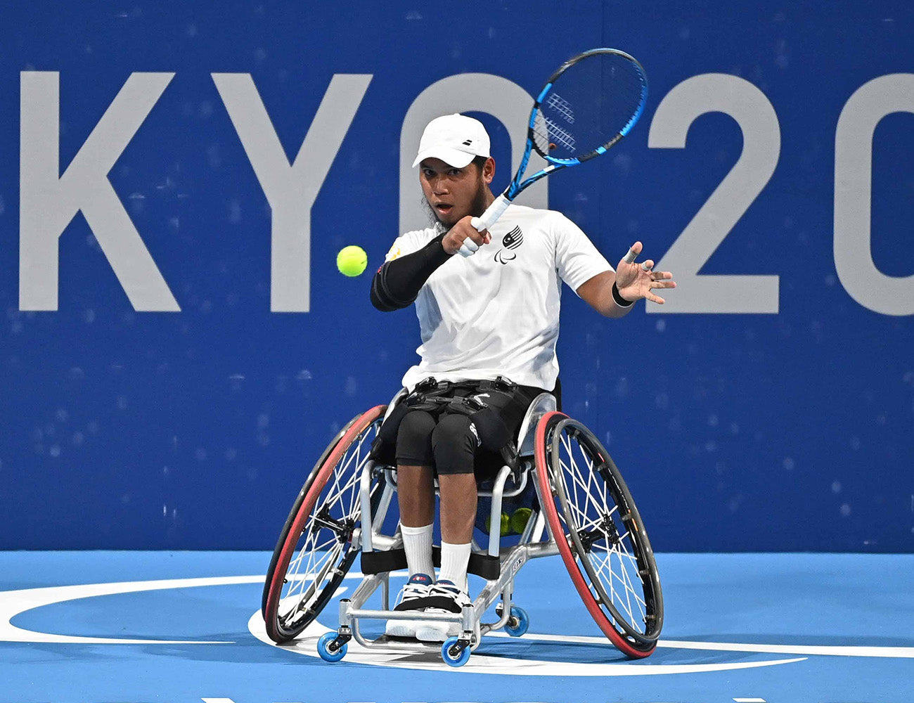 Male playing wheelchair tennis on spinergy wheels
